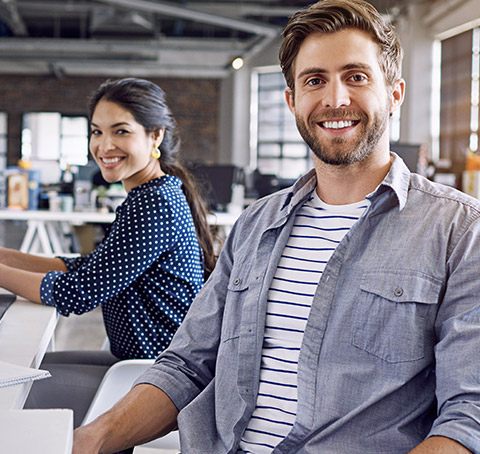 Simling business woman and man in office setting