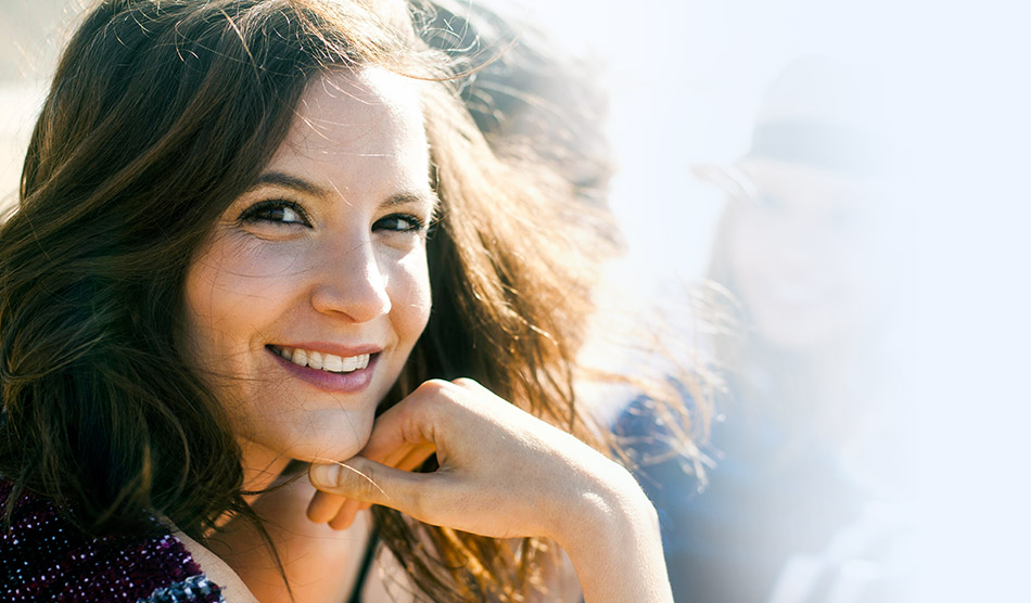 smiling woman resting her chin on her hand